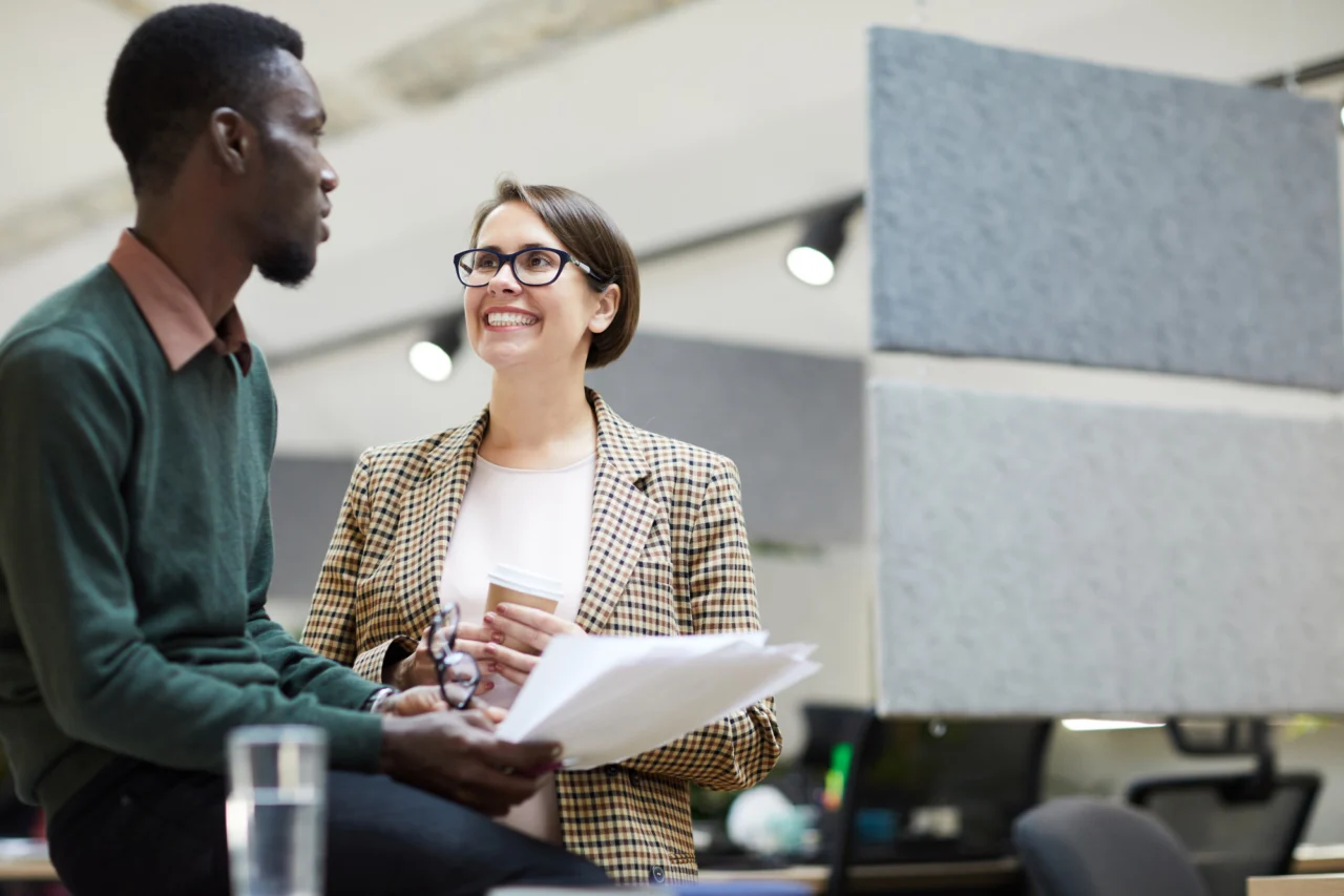 A manager handing a piece of work over to a colleague