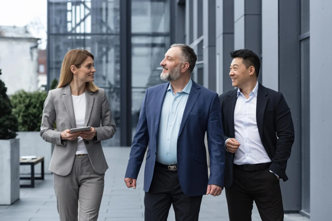 A leadership team in conversation outside the office