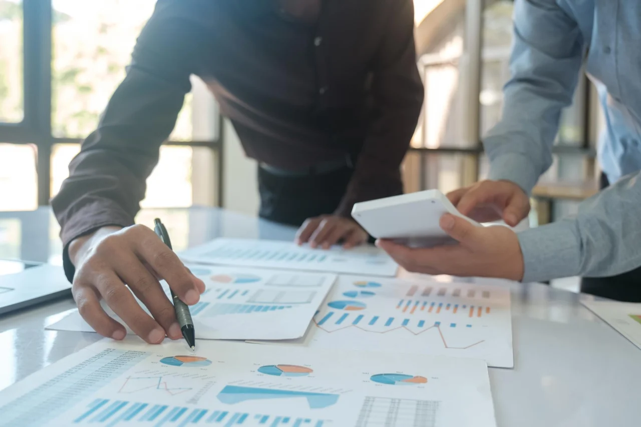 Two colleagues reviewing the financial figures together