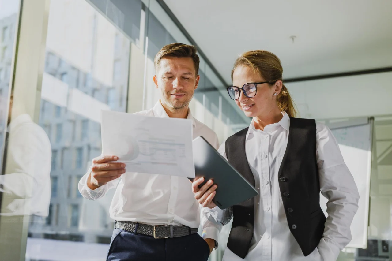 Two operators reviewing a company's numbers together at the same table