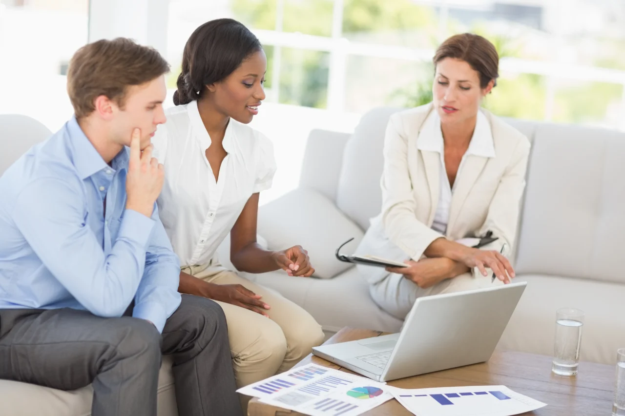 Two business people reviewing figures across a table