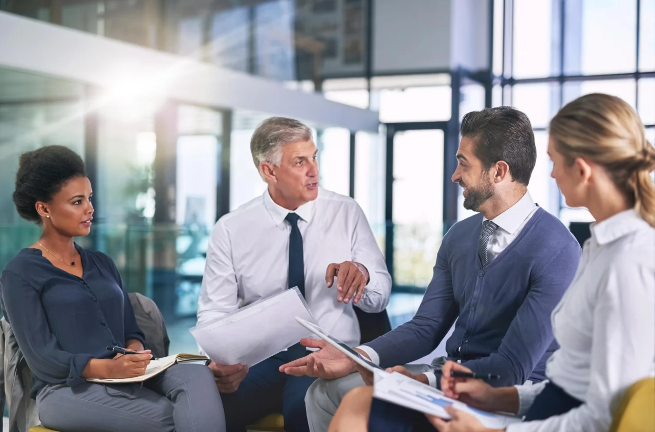A small group of business people in discussion around a table
