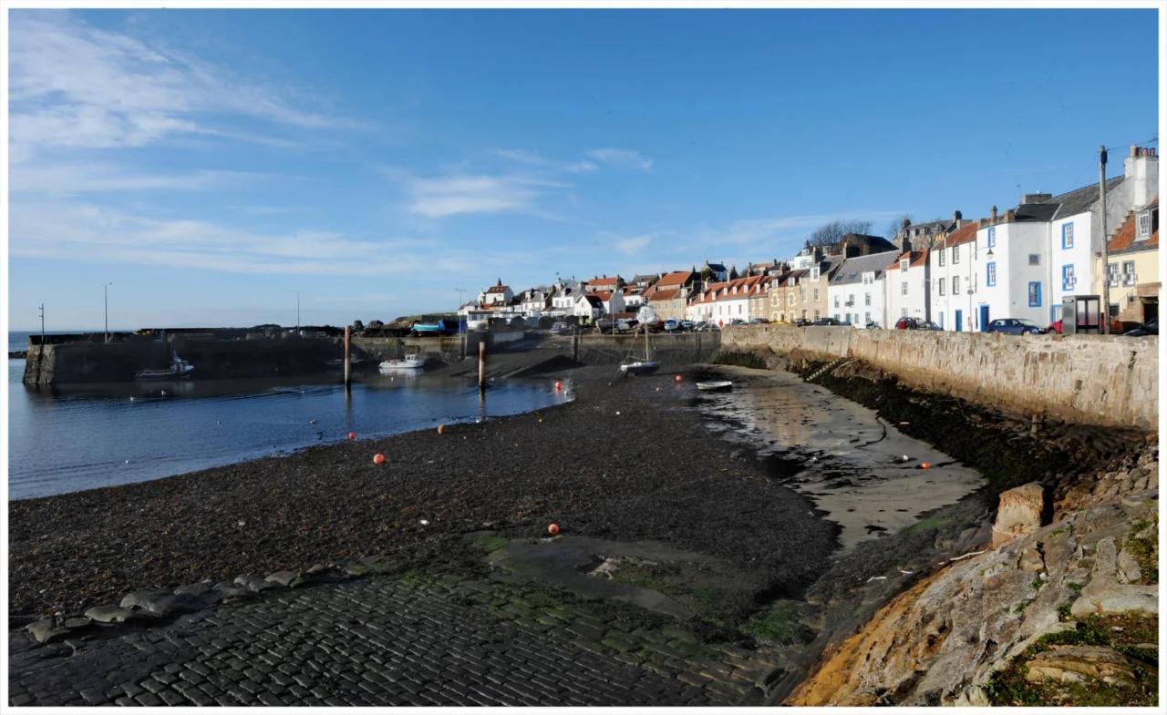 A small coastal town seen across the harbour under an overcast sky